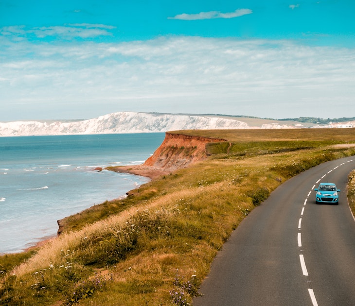 Aerial panoramic view of road with blue car on it with the Needles and sea view. The Isle of WIght, UK
2165386893